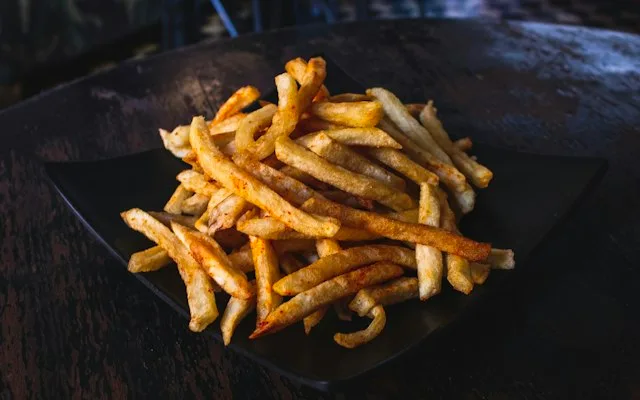 Crispy fries in a black basket, straight out of the air fryer