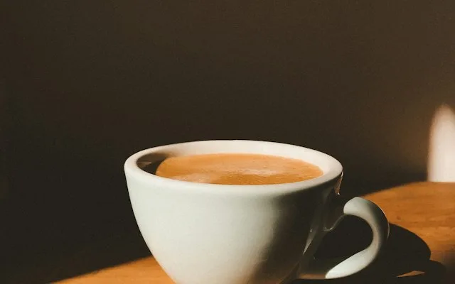 Tasse de café au lait sur une table sombre