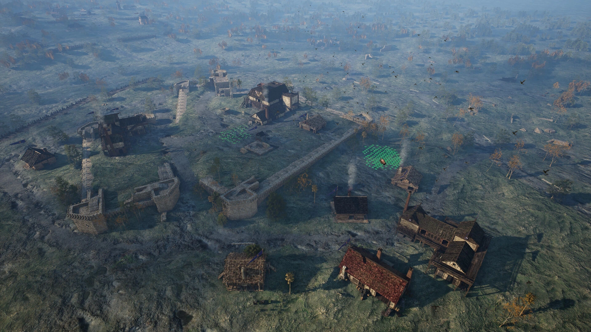 Vue aérienne d'une colonie médiévale fortifiée, avec ses murs, ses maisons et deux régiments entourés de vert