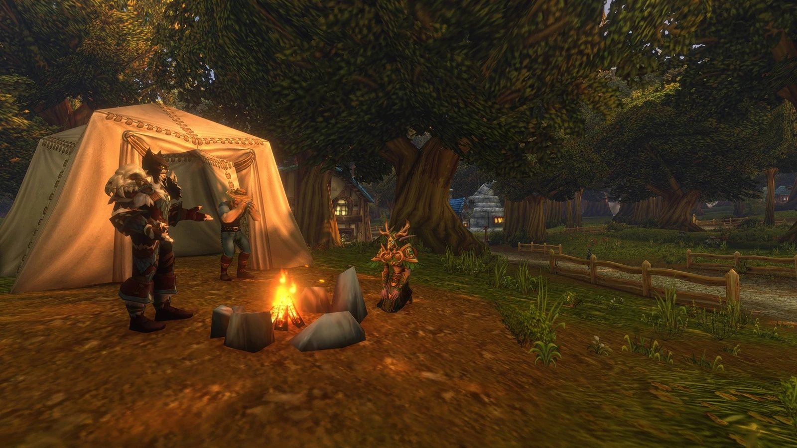 Three characters around a stone-ringed campfire in front of a large white tent, at the edge of a forest village at dusk